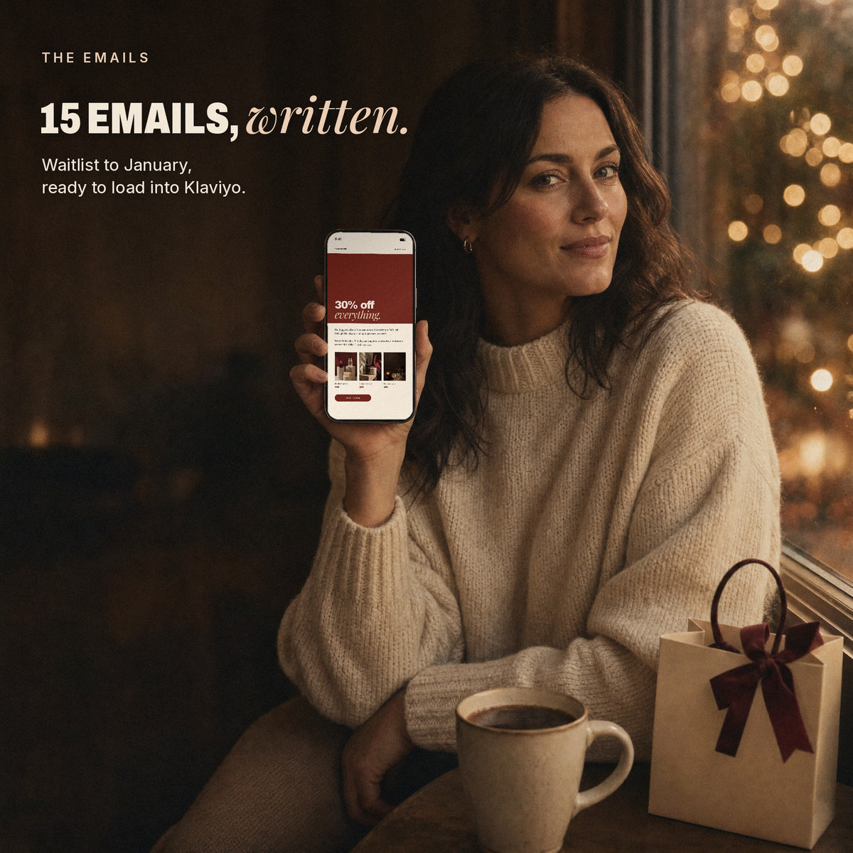 Woman holding a phone showing a Black Friday email from the kit
